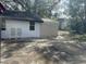 View of a garage area and the side of the house with chairs on a concrete slab at 610 Illinois Ave, St Cloud, FL 34769