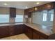 A kitchen with tiled countertops, wood cabinets and a breakfast bar at 610 Illinois Ave, St Cloud, FL 34769