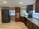 This kitchen features stainless steel appliances and wood cabinets at 610 Illinois Ave, St Cloud, FL 34769