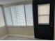 Well lit sun room with lots of windows and a black exterior door at 610 Illinois Ave, St Cloud, FL 34769