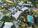 Aerial view of condos and townhomes with a community pool and well manicured landscaping at 7503 Mourning Dove Cir # 301, Reunion, FL 34747