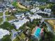 Aerial view of condos and townhomes with swimming pool and fountain near golf course and neighborhood at 7503 Mourning Dove Cir # 301, Reunion, FL 34747