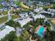 Aerial view of condos and townhomes with swimming pool and fountain near golf course and neighborhood at 7503 Mourning Dove Cir # 301, Reunion, FL 34747