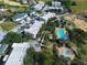 Aerial view of condos and townhomes with a community pool and fountain surrounded by lush landscaping at 7503 Mourning Dove Cir # 301, Reunion, FL 34747