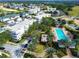 Aerial view of condos and townhomes with swimming pool and fountain near golf course and neighborhood at 7503 Mourning Dove Cir # 301, Reunion, FL 34747