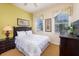 Bright bedroom has two windows, ceiling fan, double bed, and a wooden dresser at 7503 Mourning Dove Cir # 301, Reunion, FL 34747