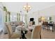 Inviting dining area featuring a glass-topped table, comfortable seating, and modern lighting at 7503 Mourning Dove Cir # 301, Reunion, FL 34747