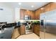 Well-equipped kitchen featuring stainless steel appliances, dark granite countertops and wood cabinets at 7503 Mourning Dove Cir # 301, Reunion, FL 34747