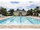 Resort-style pool with lounge chairs and palm tree landscaping at 7503 Mourning Dove Cir # 301, Reunion, FL 34747