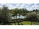 Inviting community pool is surrounded by lush greenery and palm trees at 7503 Mourning Dove Cir # 301, Reunion, FL 34747