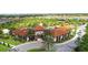 Aerial view of a resort-style clubhouse entrance surrounded by lush landscaping at 7622 Oakmoss Loop, Davenport, FL 33837