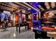 This very large game room includes a bar, pool table, foosball table, and gaming chairs at 7622 Oakmoss Loop, Davenport, FL 33837