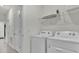 Well-equipped laundry room with modern appliances and ample storage at 7622 Oakmoss Loop, Davenport, FL 33837