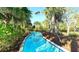 Serene lazy river winding through lush landscaping, offering a relaxing amenity at 7622 Oakmoss Loop, Davenport, FL 33837