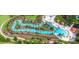 Aerial view of the community's beautiful winding lazy river surrounded by trees at 7622 Oakmoss Loop, Davenport, FL 33837