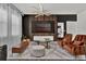 Stylish living room boasting a modern light fixture, statement wall, comfortable seating, and a cozy atmosphere at 7622 Oakmoss Loop, Davenport, FL 33837