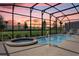 Screened swimming pool and hot tub with stunning sunset views at 7622 Oakmoss Loop, Davenport, FL 33837