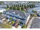 Aerial view of townhomes with blue shutters and manicured front yards at 7682 Fitzclarence St, Kissimmee, FL 34747