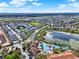 Sprawling aerial view of neighborhood featuring houses, a pool, and waterpark at 7682 Fitzclarence St, Kissimmee, FL 34747