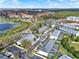 Overhead shot of a townhome complex with a lake, community pool, and landscaping, ideal for outdoor enjoyment at 7682 Fitzclarence St, Kissimmee, FL 34747