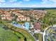 Beautiful aerial view of community with clubhouse, community pool, and splashpad at 7682 Fitzclarence St, Kissimmee, FL 34747