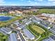 Aerial view of a townhome community featuring green spaces, landscaping, and nearby recreational amenities at 7682 Fitzclarence St, Kissimmee, FL 34747