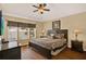 Relaxing bedroom with a king-size bed, ceiling fan, and side tables with lamps at 7682 Fitzclarence St, Kissimmee, FL 34747