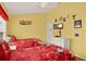 Bright bedroom featuring twin beds, a ceiling fan, and a white dresser with a TV at 7682 Fitzclarence St, Kissimmee, FL 34747