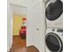 Convenient laundry area featuring a stacked washer and dryer at 7682 Fitzclarence St, Kissimmee, FL 34747