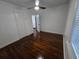 This bedroom features hardwood floors, white walls, natural light and a closet at 7709 Bell Blvd, Orlando, FL 32810