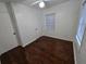 This bedroom features hardwood floors, white walls, natural light and a closet at 7709 Bell Blvd, Orlando, FL 32810