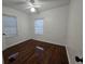 This bedroom features hardwood floors, white walls, and natural light at 7709 Bell Blvd, Orlando, FL 32810