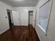 This bedroom features hardwood floors, white walls, natural light and a closet at 7709 Bell Blvd, Orlando, FL 32810