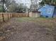 Exterior shot of a fenced yard with a long driveway at 7709 Bell Blvd, Orlando, FL 32810