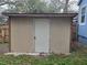 The shed has siding, a door, concrete blocks, and a shingle roof at 7709 Bell Blvd, Orlando, FL 32810