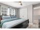 A bedroom featuring a queen bed, large closet and bright window at 7761 Tosteth St, Kissimmee, FL 34747