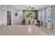 Bright dining room featuring a large table, six chairs, ceiling fan, and a decorative accent wall at 7761 Tosteth St, Kissimmee, FL 34747