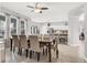 Open dining area featuring tile floors, neutral paint, ceiling fan, and natural light from the windows at 7761 Tosteth St, Kissimmee, FL 34747