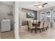 Elegant dining room featuring neutral decor, large windows, and a modern ceiling fan at 7761 Tosteth St, Kissimmee, FL 34747