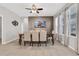 Neutral dining area with tile flooring, decorative wallpaper, and large windows at 7761 Tosteth St, Kissimmee, FL 34747