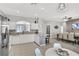 Open kitchen featuring stainless steel appliances, a tile backsplash, and an adjacent dining area at 7761 Tosteth St, Kissimmee, FL 34747