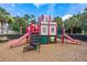 Playground with castle-themed climbing structure, slides and a wood chip safety ground cover at 7761 Tosteth St, Kissimmee, FL 34747