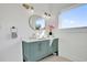 Stylish bathroom with a blue vanity, white countertop, gold hardware, and ample natural light at 802 S 10Th St, Haines City, FL 33844