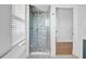 Modern bathroom with a glass door shower showcasing decorative tiles and gold fixtures at 802 S 10Th St, Haines City, FL 33844