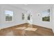 Bedroom with 3 windows showing a tree filled view and hardwood floors at 802 S 10Th St, Haines City, FL 33844