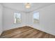 Bright bedroom with two windows and wood-look flooring at 802 S 10Th St, Haines City, FL 33844