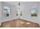 Bright bedroom with three arched windows and hardwood floors, showcasing natural light and classic architecture at 802 S 10Th St, Haines City, FL 33844