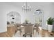 Elegant dining room boasts a modern chandelier, arched doorways, and seating for four at 802 S 10Th St, Haines City, FL 33844