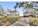 A grand two-story home with a Mediterranean-style roof and a detached garage apartment at 802 S 10Th St, Haines City, FL 33844