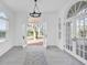 Bright foyer featuring arched doorways, decorative tile, and grand chandelier lighting at 802 S 10Th St, Haines City, FL 33844